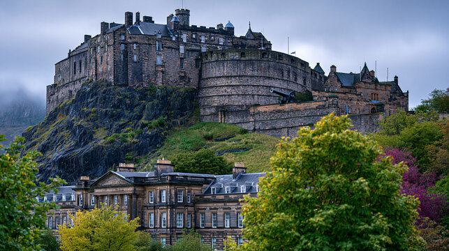Edinburgh Castle volcanic basalt crag rising from Carboniferous sill intrusion, Mons Meg iron bombard on medieval battery wall, ashlar rubble masonry contrasting with polished Palace of Holyroodhous