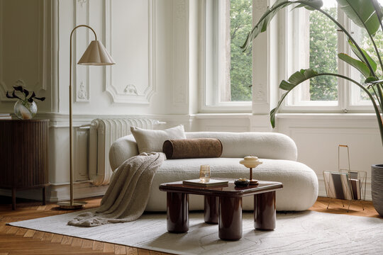 Minimalist living room with modern elegant furniture, large window, and cozy soft decor in a spacious apartment