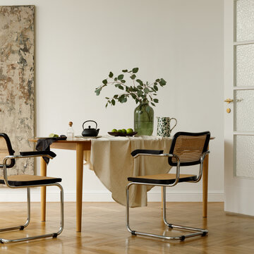 Minimalist Dining Room with Modern Chairs, Wooden Table, and Greenery Decor