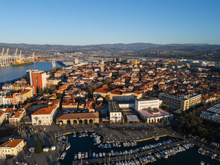 Obraz premium The view shows Koper, Slovenia with its marina, city buildings, and waterfront along the Adriatic Sea during daylight.