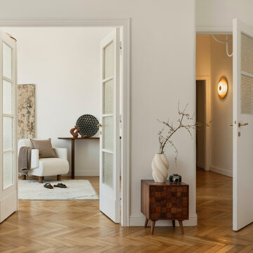 Inviting Interior Room with Open Doors and Stylish Decor, Warm Light Illuminates a Cozy Home Space Through Archways