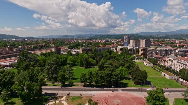 Aerial drone view of Campo Marzo Park in Vicenza, Italy, featuring expansive green spaces, tree-lined pathways, recreational areas, and the surrounding urban landscape
