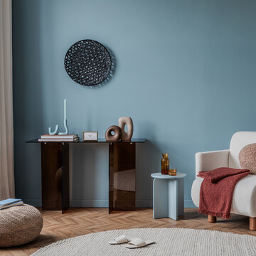 Minimalist living room interior with modern furniture and blue walls, creating a calm and inviting atmosphere