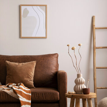 Stylish Living Room Interior with Brown Sofa, Decorative Pillow, Blanket, and Modern Art Print on Wall in Home