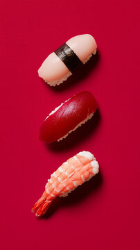 Three pieces of sushi on a red background