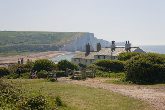Cottages and the Seven Sisters cliffs in East Sussex, UK