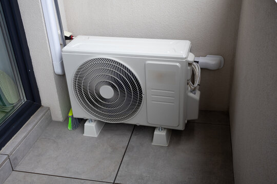 Outdoor Air Conditioner Compressor Unit Installed on Balcony Floor