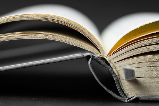 Close-up of an open book binding and pages