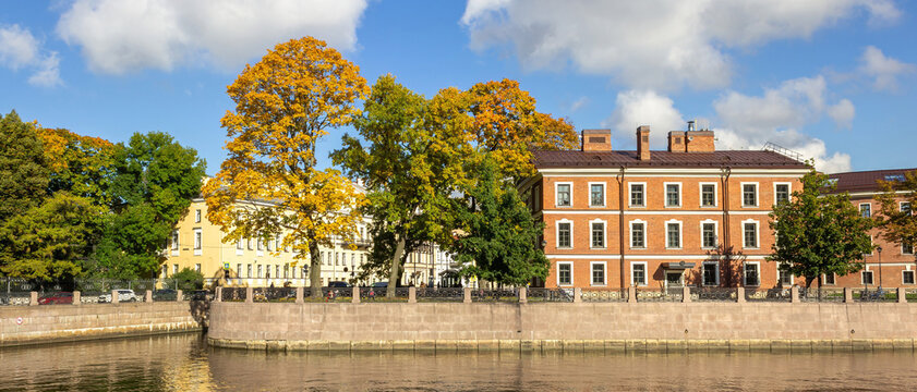 Ultra wide cinematic St Petersburg cityscape with Moika River embankment and historic buildings. Autumn panorama for banners and hero images