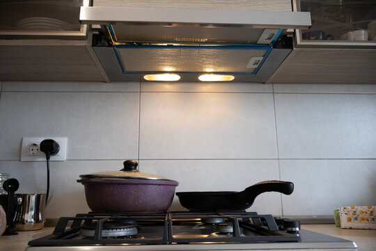 Close Up of Gas Cooktop with Cooking Pot and Range Hood