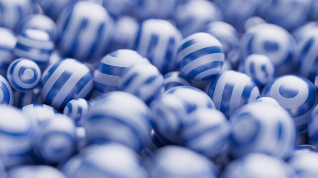 Endless hypnotic waves dancing around spheres. A vibrant collection of blue and white striped spheres fills the frame, creating a playful and textured pattern.