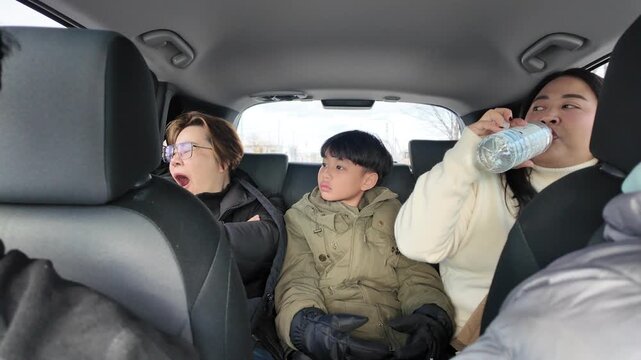 driving car. Family travel and Vacation together, happy parents and their excited kids smiling driving car in winter. Young family traveling abroad by car. Family trip. Auto tourism