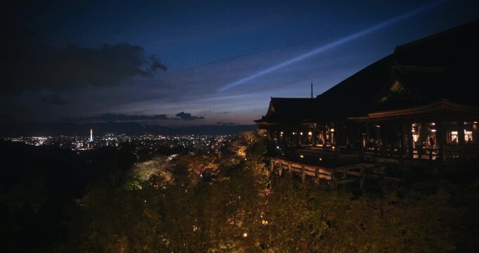 Old 8th century kiyomizu-dera Japanese temple on hill top with city lights