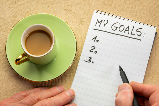 my goals list - handwriting in a notebook with cup of coffee