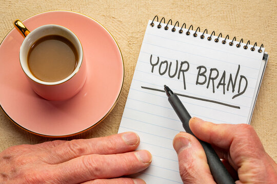 your brand word abstract - handwriting in black ink in a notebook with coffee