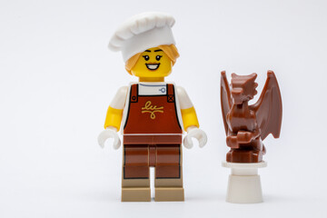 Obraz premium A minifigure of a chocolatier making a chocolate dragon