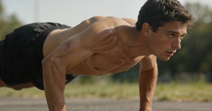 Man performs push ups outdoor daytime fitness workout