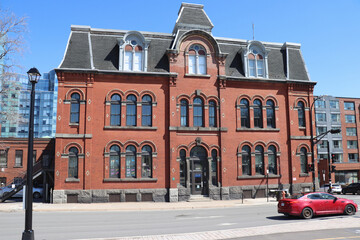 Obraz premium HALIFAX, CANADA - MAY 2026: Scenic city views of downtown Halifax, Nova Scotia, featuring the historic Citadel Town Clock, traditional brick architecture, and modern buildings under a clear blue sky. 