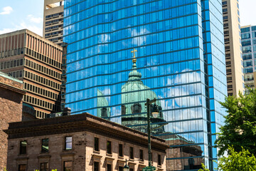Reflection of the Cathedral Basilica dome in a modern glass facade in Philadelphia, Pennsylvania, showing contrast of historic and contemporary architecture. © Nicola
