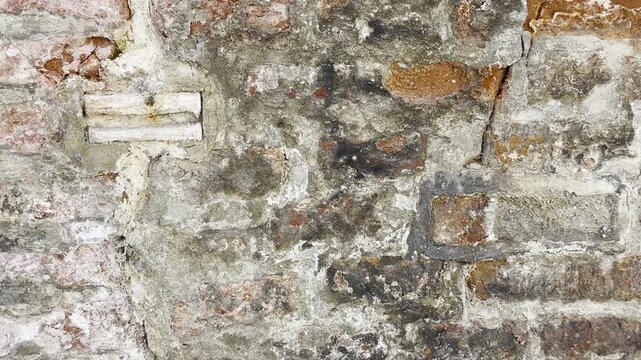Ancient European stone wall creates textured grunge background plate