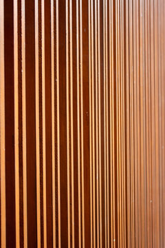 Side perspective of vertical merbau wooden louver cladding wall giving a warm and natural feel to the architecture.
