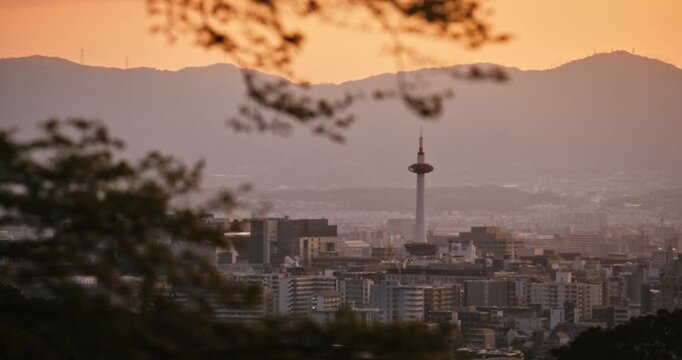 Majestic view of Japanese city with sunset glow over it - panning shot