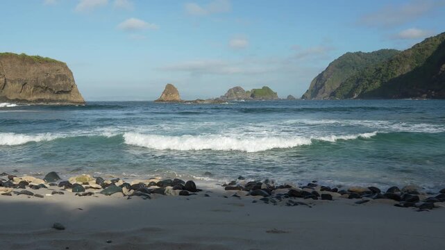 Beautiful sea waves crashing on Papuma Beach in Jember with authentic ambient sound of rushing water. Papuma Beach, Jember, Indonesia