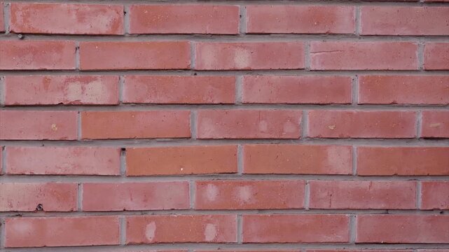 Red brick wall background, texture of orange clay bricks with cement joints, abstract clean masonry pattern backdrop, architectural surface for copy space