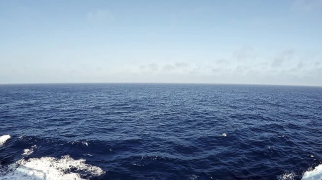 Sailing through endless shades of blue. Stunning ocean view from a cruise ship. Nothing but deep blue waters and open skies