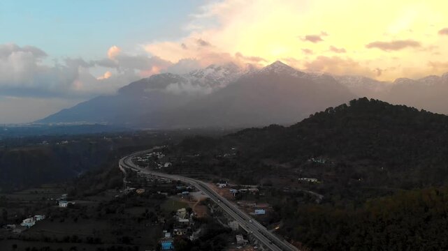 Aerial pullback of Trikuta hills and Katra highway at sunset.