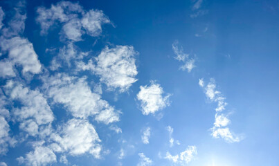 Beautiful bright blue sky with scattered soft white cumulus clouds. A crisp, natural background perfect for themes of travel, weather, and fresh air concepts. © Indah Alfath