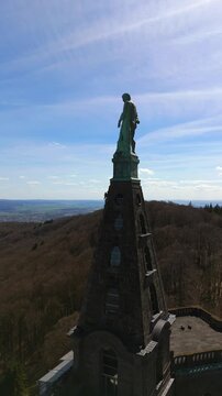 Kassel, Germany - April 6, 2026: Hercules statue vertical aerial close up video on the monument spire Kassel