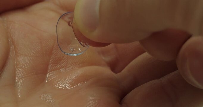 Macro Close Up of Picking Up Clean Contact Lens with Fingers