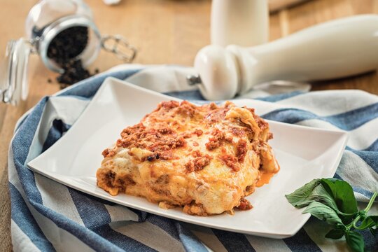 Warm and inviting, this mouthwatering lasagna showcases rich layers of pasta, savory meat, and creamy cheese, all beautifully served on a simple plate. A feast for the senses awaits