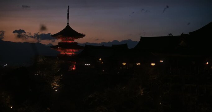 Glowing, silhouetted, ancient Japanese village at dusk - wide shot