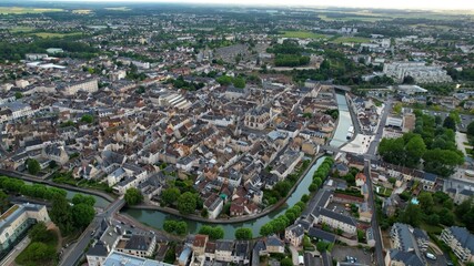 Obraz premium Panoramic aerial view around the old town of the city Montargis in France on a cloudy spring day