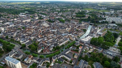 Obraz premium Panoramic aerial view around the old town of the city Montargis in France on a cloudy spring day