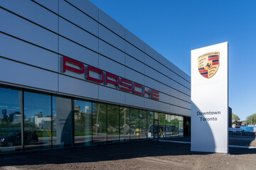Naklejka premium Toronto, ON, Canada - May 30, 2026: Porsche Centre Downtown Toronto dealership on Cherry Street in Toronto, ON, Canada. Porsche is a German car manufacturer. 