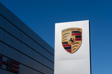 Naklejka premium Toronto, Ontario, Canada - May 30, 2026: Porsche crest at a Porsche Centre. Toronto, Ontario, Canada. Porsche is a German car manufacturer. 