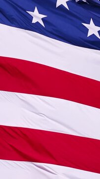Close up of the US Flag blowing in the breeze. Vertical Video.