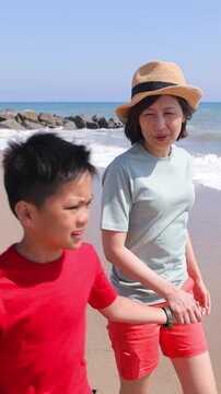 Mother and Son enjoy a day at the beach. Los Angeles. Vertical video.