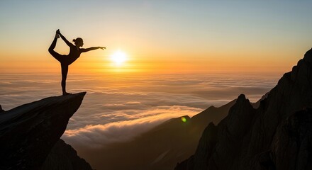 Fototapeta premium Celebrating yoga day silhouette of woman performing yoga pose on mountain peak at sunrise