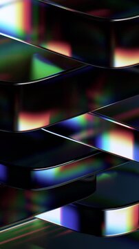 Abstract iridescent glass shapes on a black background, vertical 4k seamless loop 3d animation