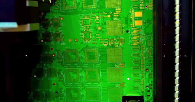 Automated industrial robot tester inspects microchips and components on a motherboard. Closeup of advanced technology, equipment, and digital hardware quality assessment.