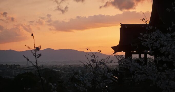 Silhouette of ancient Japanese building with view of city - steady cam movement