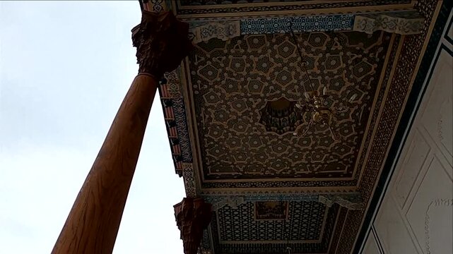 Intricately painted wooden ceiling and carved pillars of Bolo Hauz mosque in Bukhara