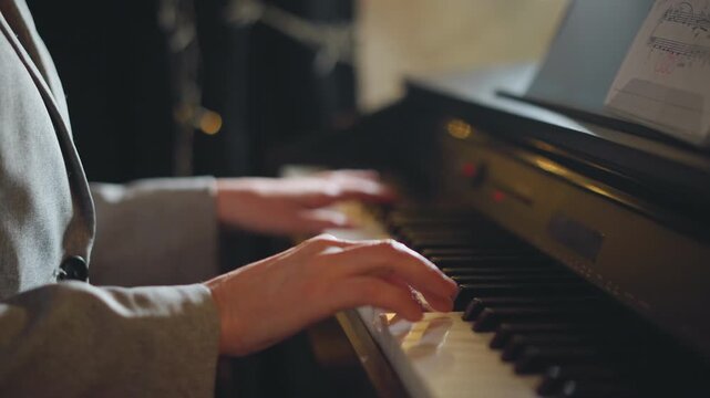Closeup white student hands on piano keys, soft bokeh lights and sheet music, focused practice session in cozy studio, precise fingering and warm expression, diligent technique in quiet atmosphere.