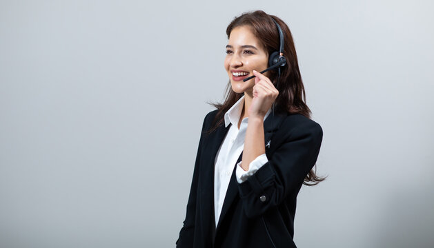 Attractive business woman in suits and headsets are smiling while working isolate on white background. Customer service assistant working in office. VOIP Helpdesk headset