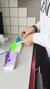 Diepenbeek. Filling a weekly pill organizer with medication at home
