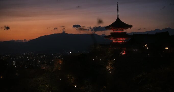 Epic view of gorgeous 8th century Japanese temple on hill with view of city at dusk
